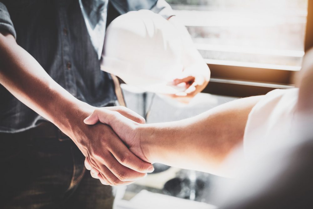 Business Cooperation, Construction, Design agreement concept. Handshake between designer engineers